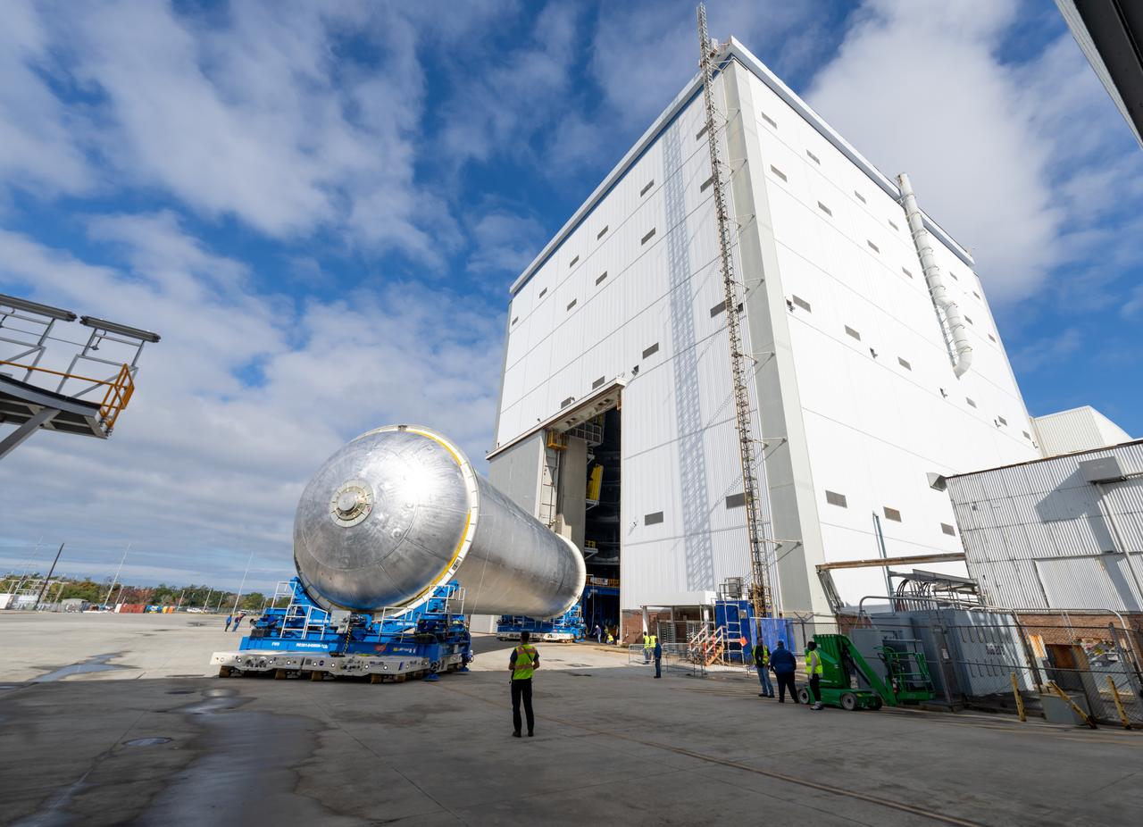 Teams move the core stage liquid hydrogen tank for the Artemis III mission to a priming cell near the Vertical Assembly Building at NASA’s Michoud Assembly Facility in New Orleans Nov. 21. Technichians will sand down and prepare the suface of the tank before coating it in a primer. Primer is applied to the barrel section of the tank by an automated robotic tool, whereas the forward and aft domes are primed manually.   Once priming is complete, technicians with NASA and Boeing, the SLS core stage prime contractor, will apply a foam-based thermal protection system, which protects the propellant tank from the extreme temperatures it will face during launch and flight while also regulating the super-chilled propellant within it. The propellant tank is one of five major elements that make up the 212-foot-tall rocket stage. The core stage, along with its four RS-25 engines, produce two million pounds of thrust to help launch NASA’s Orion spacecraft, astronauts, and supplies beyond Earth’s orbit and to the lunar surface for Artemis.   